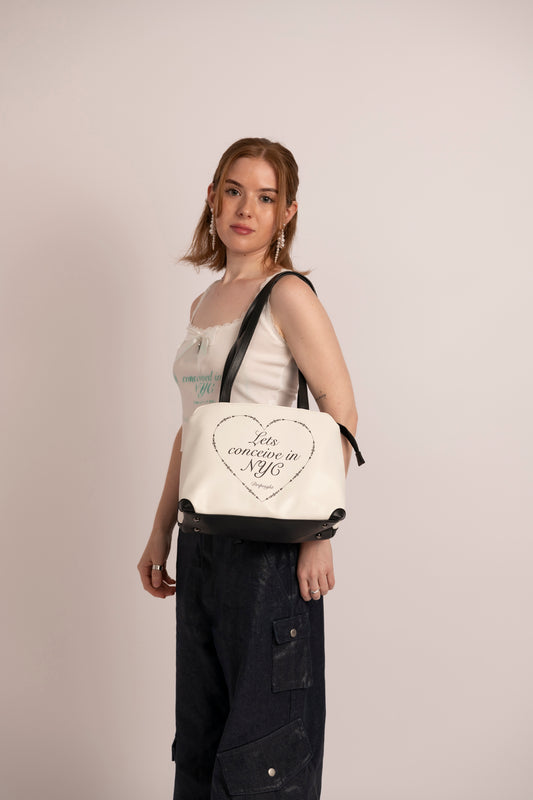 conceived in nyc but in a heart shoulder bag